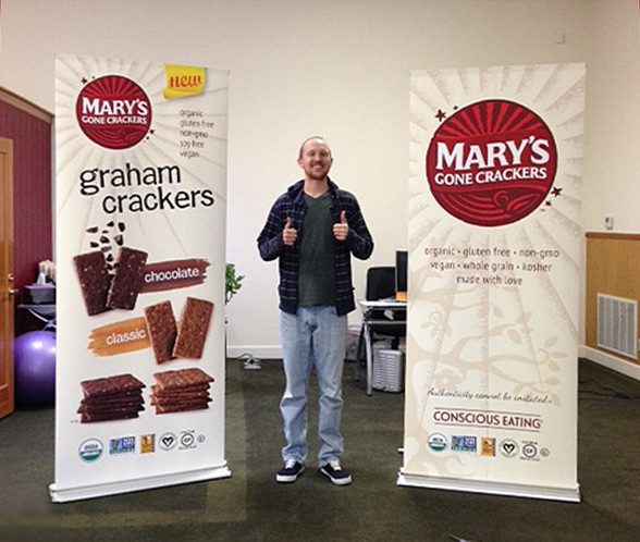 Casey From Mary's Gone Crackers with banners in retractable stands